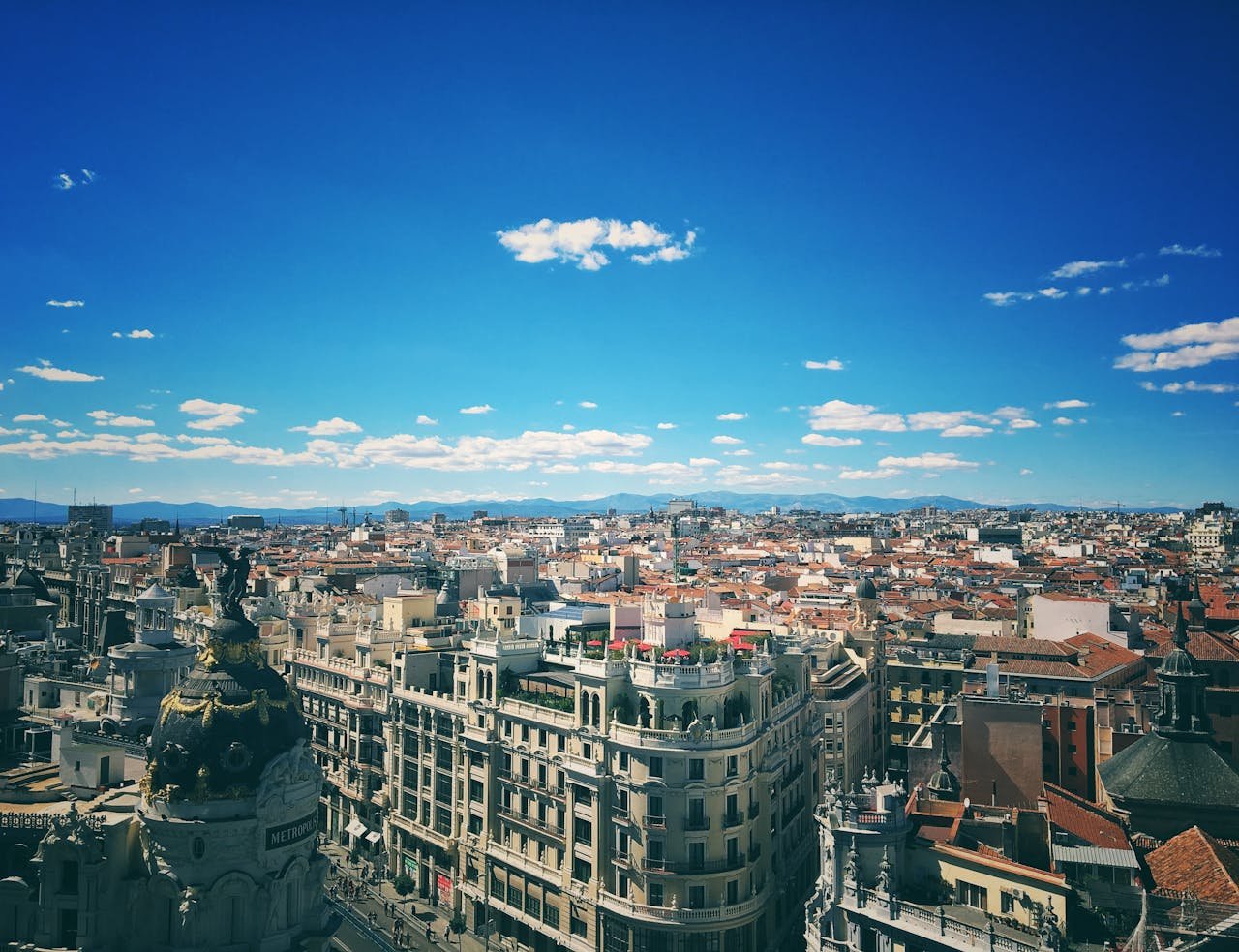 A breathtaking aerial view of Madrids vibrant cityscape under a clear blue sky.